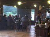 The Establo lounge at Estancia Bonanza, with tables by the window and the kitchen bar